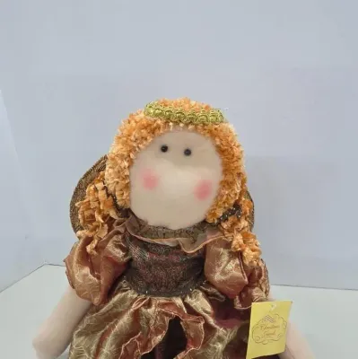 Handmade fabric angel doll featuring curly yarn hair with a gold tiara and a metallic brocade dress.