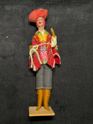 Vintage Peruvian folk art doll depicting a man in traditional Andean attire on a wooden base.