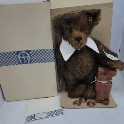 Collectible Knickerbocker Toy Co. dark brown mohair teddy bear with white collar, ear button, accessory satchel, and original box with...