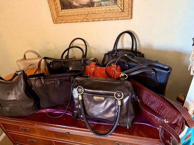 Collection of women's leather and synthetic handbags in various styles and colors, including a Kenneth Cole Reaction black satchel...