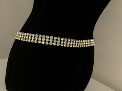 Sale Photo Thumbnail #75: Vintage silver-tone costume jewelry piece featuring three rows of prong-set clear round rhinestones. Includes a hook closure and extension tail. Versatile design can be worn as a choker necklace or a waist belt depending on measurements. Good vintage cond
