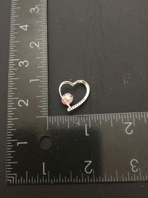 Sale Photo Thumbnail #13: A silver-tone open heart charm or pendant featuring a pink faux-pearl accent and small clear rhinestone accents along one side. Measures approximately 3/4 inch wide by 3/4 inch high. Good pre-owned condition with light wear.