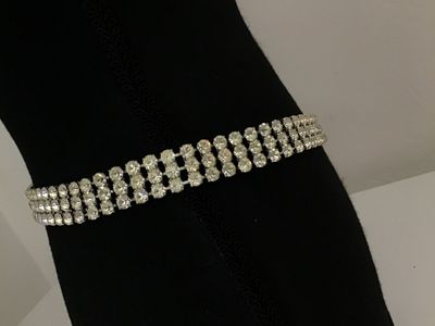Sale Photo Thumbnail #71: Vintage silver-tone costume jewelry piece featuring three rows of prong-set clear round rhinestones. Includes a hook closure and extension tail. Versatile design can be worn as a choker necklace or a waist belt depending on measurements. Good vintage cond