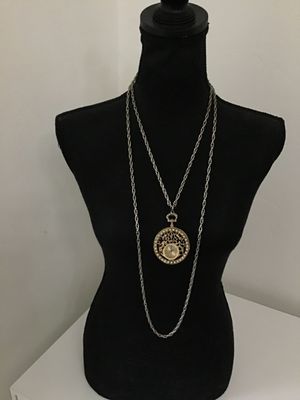 Sale Photo Thumbnail #23: Vintage West 17 pendant watch featuring a decorative ornate filigree medallion housing encircled with faux pearls. The watch face features Roman numerals. Includes a long   Not tested silver-tone chain. Marked 'West 17' on the watch dial. Metal shows ligh