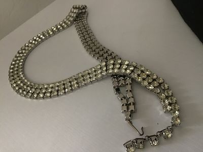 Sale Photo Thumbnail #82: Vintage silver-tone costume jewelry piece featuring three rows of prong-set clear round rhinestones. Includes a hook closure and extension tail. Versatile design can be worn as a choker necklace or a waist belt depending on measurements. Good vintage cond