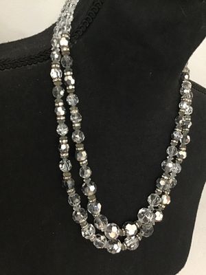 Sale Photo Thumbnail #51: A vintage double-strand necklace featuring faceted clear crystal glass beads accented with rhinestone rondelle spacers and a decorative crystal cluster clasp. Shows mid-century styling. Good condition with light vintage wear visible on the spacer metals.