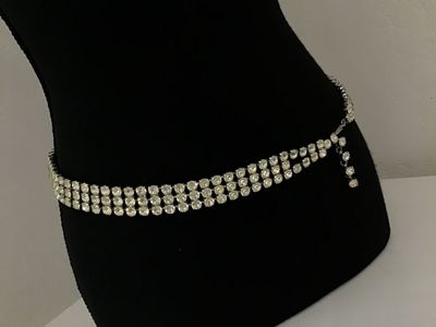 Sale Photo Thumbnail #67: Vintage silver-tone costume jewelry piece featuring three rows of prong-set clear round rhinestones. Includes a hook closure and extension tail. Versatile design can be worn as a choker necklace or a waist belt depending on measurements. Good vintage cond