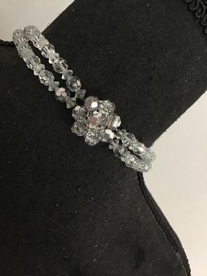 Sale Photo Thumbnail #49: A vintage double-strand necklace featuring faceted clear crystal glass beads accented with rhinestone rondelle spacers and a decorative crystal cluster clasp. Shows mid-century styling. Good condition with light vintage wear visible on the spacer metals.