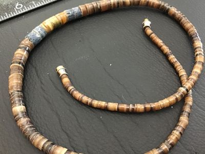 Sale Photo Thumbnail #228: A vintage-style Native American Southwestern-inspired beaded necklace featuring sliced heishe shell disc beads and accent stone beads. The necklace features a barrel screw clasp. Good pre-owned condition with natural variations in the shell and stone bead