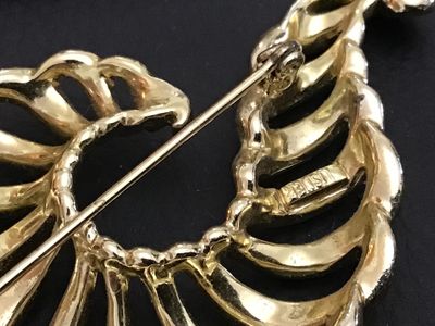 Sale Photo Thumbnail #184: A vintage gold-tone costume jewelry brooch featuring an openwork spiral shell or swirl design. Marked 'LISNER' on the back. Features a standard pin mechanism with rolling C-clasp. Shows light pre-owned wear consistent with age.