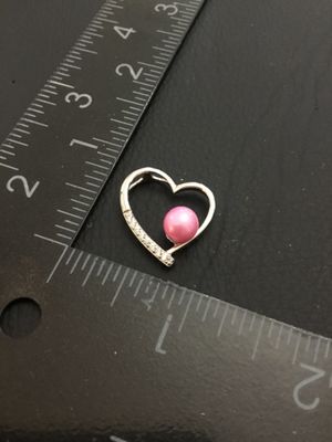 Sale Photo Thumbnail #15: A silver-tone open heart charm or pendant featuring a pink faux-pearl accent and small clear rhinestone accents along one side. Measures approximately 3/4 inch wide by 3/4 inch high. Good pre-owned condition with light wear.