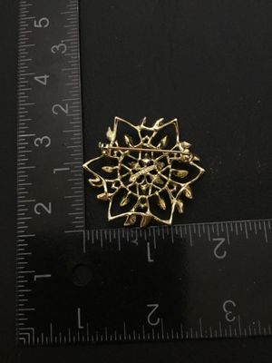 Sale Photo Thumbnail #33: Vintage Sarah Coventry gold-tone openwork floral brooch pin featuring textured leaf and petal details. Measures approximately 1.75 inches in diameter. Signed Sarah Coventry on the back. Includes a standard pin back with a safety clasp mechanism. In good v