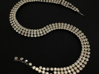 Sale Photo Thumbnail #85: Vintage silver-tone costume jewelry piece featuring three rows of prong-set clear round rhinestones. Includes a hook closure and extension tail. Versatile design can be worn as a choker necklace or a waist belt depending on measurements. Good vintage cond