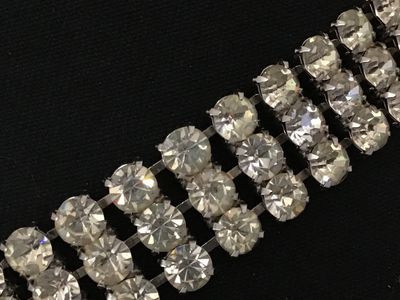 Sale Photo Thumbnail #78: Vintage silver-tone costume jewelry piece featuring three rows of prong-set clear round rhinestones. Includes a hook closure and extension tail. Versatile design can be worn as a choker necklace or a waist belt depending on measurements. Good vintage cond