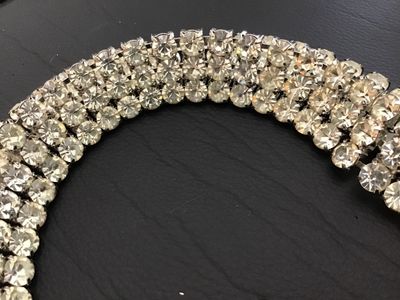 Sale Photo Thumbnail #86: Vintage silver-tone costume jewelry piece featuring three rows of prong-set clear round rhinestones. Includes a hook closure and extension tail. Versatile design can be worn as a choker necklace or a waist belt depending on measurements. Good vintage cond