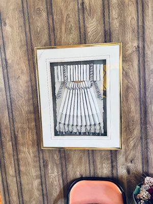 Framed 3D paper sculpture artwork featuring pleated fans and patterned tassels, mounted in a thin gold-tone frame.