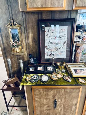 Collection of framed artwork and miniature portraits, including a large sheet music art print with skeletal keys, small ornate oval...