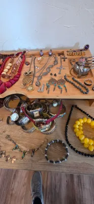 Sale Photo Thumbnail #17: An assortment of vintage fashion and costume jewelry, including beaded necklaces, pendant chains, dreamcatcher earrings, and various wristwatches displayed on a wooden organizer.