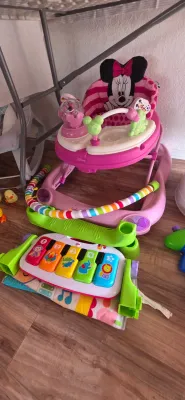Sale Photo Thumbnail #13: Disney Minnie Mouse baby walker paired with a Fisher-Price Kick & Play piano mat, both showing gentle wear.