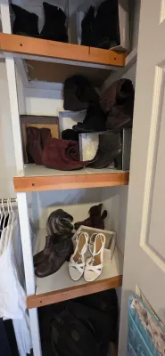 Sale Photo Thumbnail #34: Closet shelving unit filled with a variety of women's boots, heeled shoes, and white strappy sandals.
