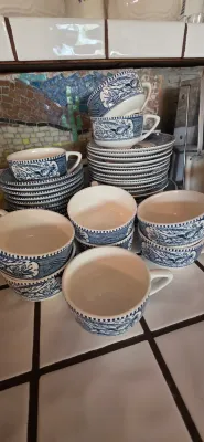 Sale Photo Thumbnail #27: Collection of blue and white transferware tea cups and saucers featuring detailed Western scenes.