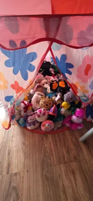 Sale Photo Thumbnail #2: Pop-up play tent with colorful floral pattern filled with an assortment of plush stuffed animals.