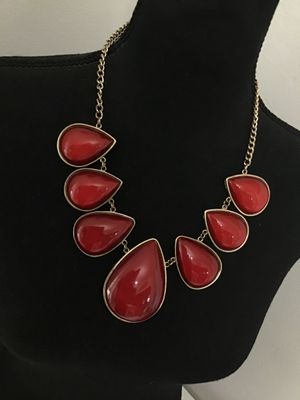 Sale Photo Thumbnail #114: Gold-tone fashion statement necklace featuring bold red teardrop cabochons set in polished gold-tone metal frames. Includes an adjustable curb chain with a lobster claw clasp and extender chain. In good pre-owned condition with no major visible flaws.