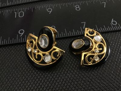 Sale Photo Thumbnail #157: Pair of vintage fan-shaped clip-on earrings featuring gold-tone metal, black enamel accents, scrollwork detailing, and clear rhinestones. Each earring measures approximately 1 inch across. Clip-on backs are functional and intact. In good vintage condition