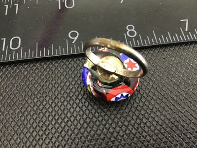 Sale Photo Thumbnail #137: Vintage costume jewelry ring featuring a colorful millefiori art glass cabochon in red, blue, green, white, and black tones. Set on a silver-tone adjustable metal band. The ring shows normal vintage wear with slight tarnish/patina on the metal band and gl