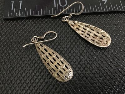 Sale Photo Thumbnail #222: Pair of vintage silver teardrop-shaped dangle earrings featuring a textured, woven basketweave design with french hook wire closures. Stamped 925 on the reverse loop connector. Measure approximately 1.5 inches in length. In good pre-owned condition with l