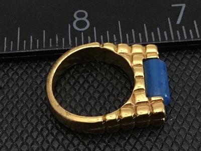 Sale Photo Thumbnail #13: Gold-tone fashion statement ring featuring a textured waffle/grid band design set with a cylindrical blue stone resembling lapis lazuli or sodalite. Ring measures approximately size 7.5 on a ring mandrel. Good pre-owned condition with light surface wear v