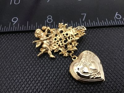 Sale Photo Thumbnail #132: Vintage gold-tone brooch pin featuring a cherub/angel motif with the words 'SOMEONE SPECIAL' in detailed scrollwork, holding a dangling opening heart locket with an engraved double-heart design. Measures approximately 2 inches wide. Pin clasp mechanism wo
