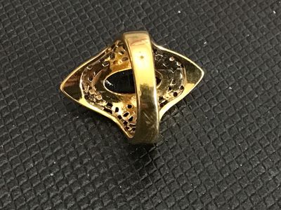 Sale Photo Thumbnail #226: Vintage statement ring featuring an oval black onyx-style cabochon set in an ornate gold-tone filigree frame. The band is stamped "18KT H.G.P." (18K Heavy Gold Electroplate). 

- Ring Size: Approximately size 5 (as measured on mandrel)
- Era/Style: Vintag