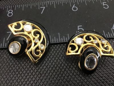 Sale Photo Thumbnail #159: Pair of vintage fan-shaped clip-on earrings featuring gold-tone metal, black enamel accents, scrollwork detailing, and clear rhinestones. Each earring measures approximately 1 inch across. Clip-on backs are functional and intact. In good vintage condition