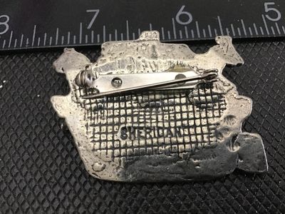 Sale Photo Thumbnail #149: A detailed pewter brooch featuring Noah's Ark with Noah and animals including an elephant and giraffe. Marked 'SHERIDAN' on the back. Measures approximately 1.75 inches wide. Good vintage condition with functional pin closure and aged patina.