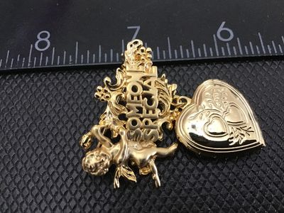 Sale Photo Thumbnail #135: Vintage gold-tone brooch pin featuring a cherub/angel motif with the words 'SOMEONE SPECIAL' in detailed scrollwork, holding a dangling opening heart locket with an engraved double-heart design. Measures approximately 2 inches wide. Pin clasp mechanism wo