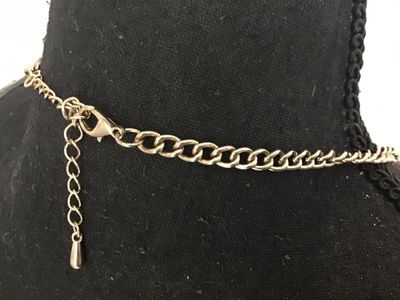 Sale Photo Thumbnail #115: Gold-tone fashion statement necklace featuring bold red teardrop cabochons set in polished gold-tone metal frames. Includes an adjustable curb chain with a lobster claw clasp and extender chain. In good pre-owned condition with no major visible flaws.