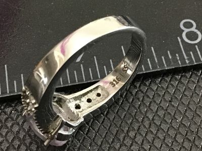 Sale Photo Thumbnail #166: Stainless steel ring featuring a central light purple oval-cut stone flanked by clear accent stones down the shoulders. Marked '316L SS' on the interior band. Ring measures approximately size 9 on the mandrel. Good condition with light surface wear.