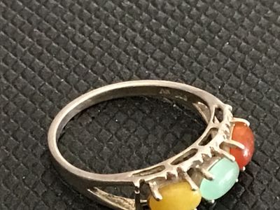 Sale Photo Thumbnail #201: Sterling silver band featuring three oval cabochons in yellow, green, and orange/red tones, possibly multi-colored jade or chalcedony. Inner band is stamped with a maker mark and sterling/925 purity mark. Measures approximately size 7.5 on a ring sizer. S