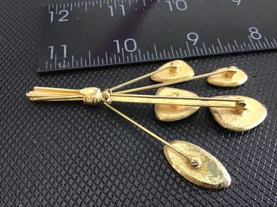 Sale Photo Thumbnail #230: A vintage Mid-Century Modern style bouquet/spray brooch pin featuring gold-tone metal with vibrant aqua turquoise and lime green enamel details. Measures approximately 3 inches long. The back features a standard pin mechanism with a safety clasp. Minor su