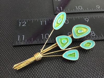 Sale Photo Thumbnail #229: A vintage Mid-Century Modern style bouquet/spray brooch pin featuring gold-tone metal with vibrant aqua turquoise and lime green enamel details. Measures approximately 3 inches long. The back features a standard pin mechanism with a safety clasp. Minor su