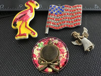 Sale Photo Thumbnail #185: Assorted vintage costume jewelry brooch pins, set of 4. Includes a plastic novelty pink flamingo brooch, a rhinestone-adorned American flag pin, a small praying angel pin, and a circular metallic brooch with a mesh center ). Items show light pre-owned sur
