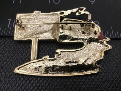 Sale Photo Thumbnail #68: Vintage gold-tone costume jewelry brooch depicting a house with a chimney and a real estate sign reading "FOR SALE" with a "SOLD" overlay. Features a pin back closure with a safety clasp. Shows light vintage wear and finish loss around the edges. Measures