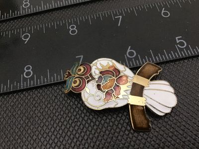 Sale Photo Thumbnail #96: Vintage cloisonné enamel brooch featuring a detailed owl perched on a branch. Styled in colorful enamel with gold-tone outlines including white, gold, burgundy, teal, and brown accents. Measures approximately 2 inches in length. Features a standard pin b