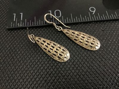 Sale Photo Thumbnail #221: Pair of vintage silver teardrop-shaped dangle earrings featuring a textured, woven basketweave design with french hook wire closures. Stamped 925 on the reverse loop connector. Measure approximately 1.5 inches in length. In good pre-owned condition with l