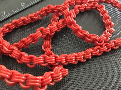 Sale Photo Thumbnail #121: Long vintage bright red molded plastic chain link necklace. Features textured, multi-strand style interlocking links. Continuous opera length style with no clasp. Good vintage condition with light wear consistent with age.