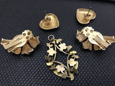 Sale Photo Thumbnail #53: A 5-piece assortment of gold-tone vintage fashion jewelry, including:
- Pair of heart-shaped pierced stud earrings with embossed scroll detail
- Pair of textured fan-shaped clip-on earrings
- Openwork floral horseshoe/teardrop pendant with bail

Condition