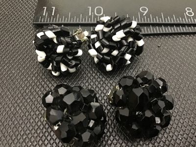 Sale Photo Thumbnail #9: Lot of two pairs of vintage clip-on cluster earrings. Includes one pair of black and white woven tube bead cluster earrings and one pair of faceted black glass/bead cluster earrings marked 'JAPAN' on the clip hardware. Both pairs measure approximately 1 i