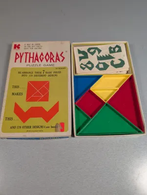 Sale Photo Thumbnail #306: Vintage 1972 Pythagoras puzzle game by Kohner Bros., complete with original colorful plastic geometric pieces, pattern cards, and box.