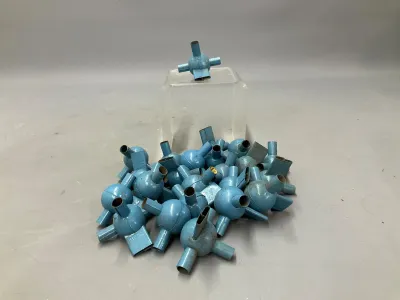 Sale Photo Thumbnail #359: Collection of vintage blue metal toy construction connectors, featuring spherical hubs with multiple attachment points, showing minor surface wear.